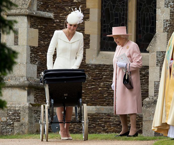 The Queen, who looked resplendent in a plush pink number, is clearly smitten with her great-granddaughter.