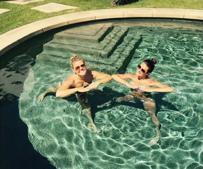 Lea Michele can't hide her glee as she and a friend strike a pose in the pool.
