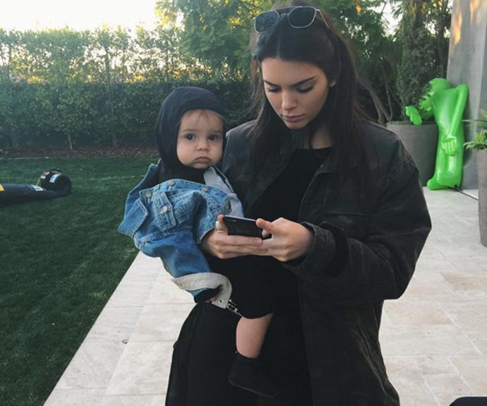 Kendall Jenner models some high-fashion mum behaviour as she squeezes in some cuddle time with her nephew, Reign Disick. Taking to Instagram to share a photo of herself affectionately holding Kourtney Kardashian's youngest, the 20-year-old captioned the snap, "Me as a mom."
