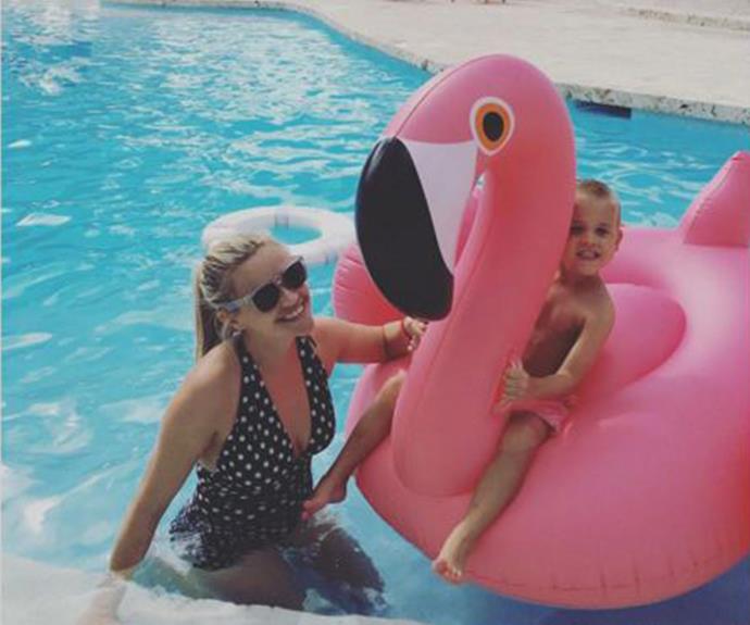"Last day of vacation!" Reese Witherspoon knows how to do it right. The actress looked stylish in a polka-dot one-piece as her son Tennessee kicked back on an oversized flamingo.