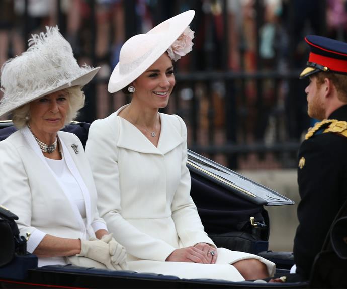Ladies in white! Duchess Camilla looks on while Kate chats to Captain Wales, himself, Prince Harry!