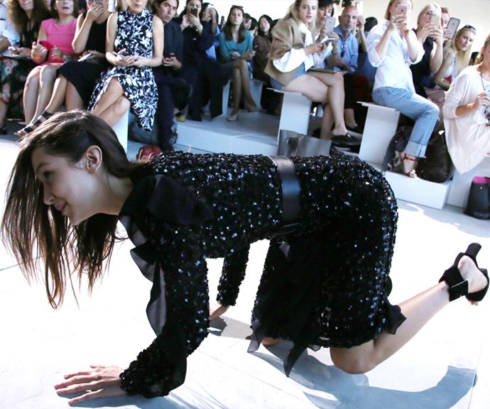 In what appeared to be a split second, the 21-year-old hit the floor in front of the eyes of the fashion world's elite. With an awkward laugh, she got herself back to her feet. **See the fall in the next slide! Gallery continues...**