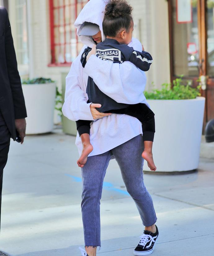 The star carried her three-year-old daughter, North, while hubby Kanye followed closely cradling their son Saint.