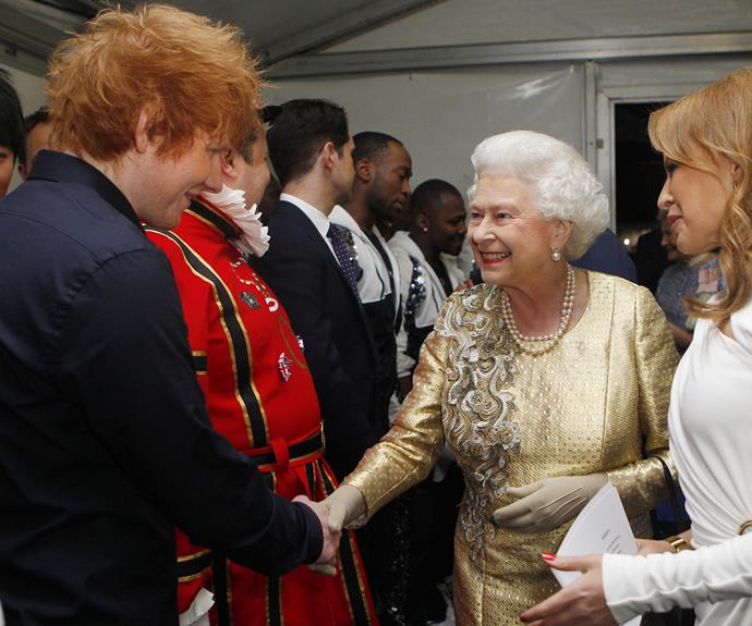Queen Elizabeth II greets British songwriter Ed Sheeran and Australian singer Kylie Minogue at the Diamond Jubilee Concert in 2012.