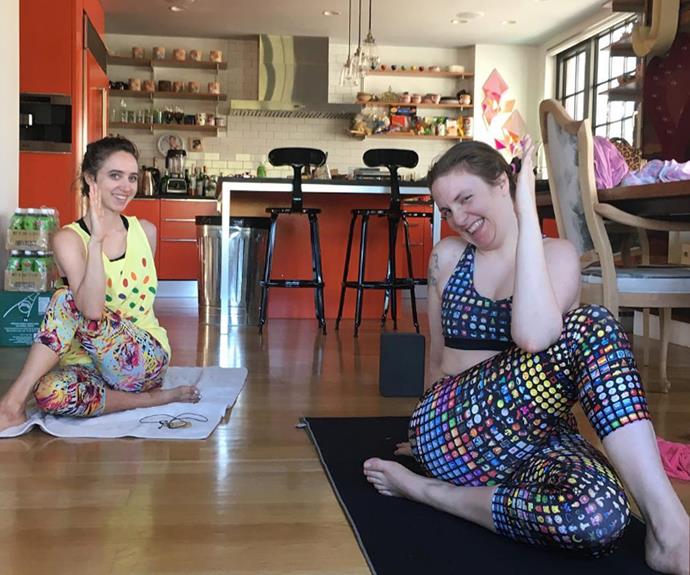 Lena Dunham opts for living room yoga with the help of a pal, proving that you don't need a gym membership or even a yoga mat if you have a towel!