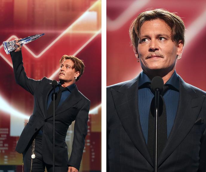 Johnny Depp raises his PCA high as he accepts the Favourite Movie Icon title.